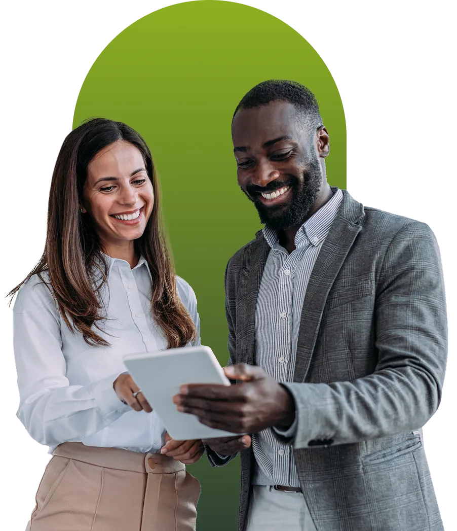 A broker and a client smiling as they review plan details together on a tablet